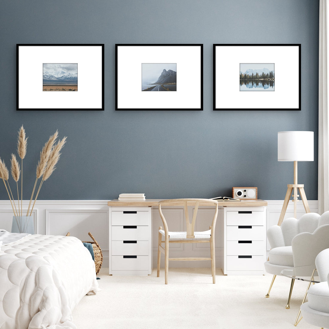 Three framed landscape photographs on blue wall. 