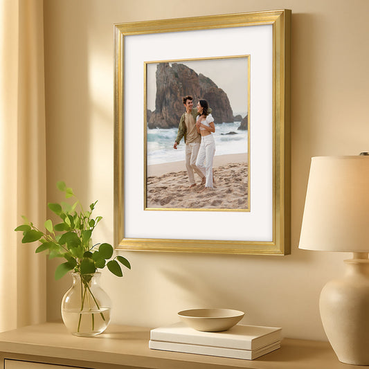 Gold picture frame displaying beach portrait with white mat.