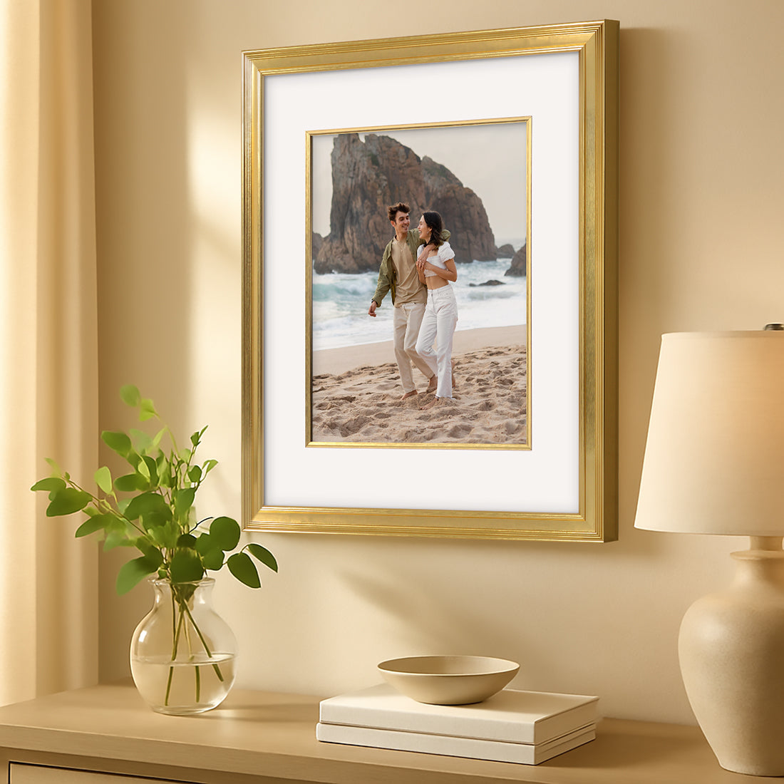 Gold picture frame displaying beach portrait with white mat.