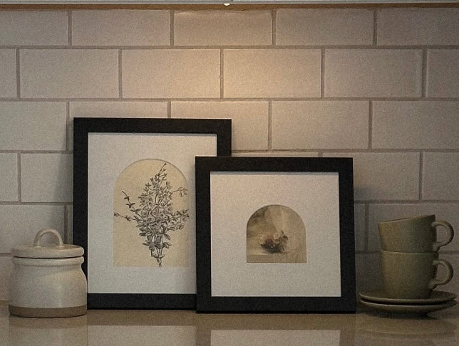 Two picture frames on kitchen countertop
