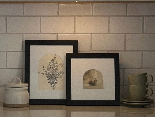 Two picture frames on kitchen countertop