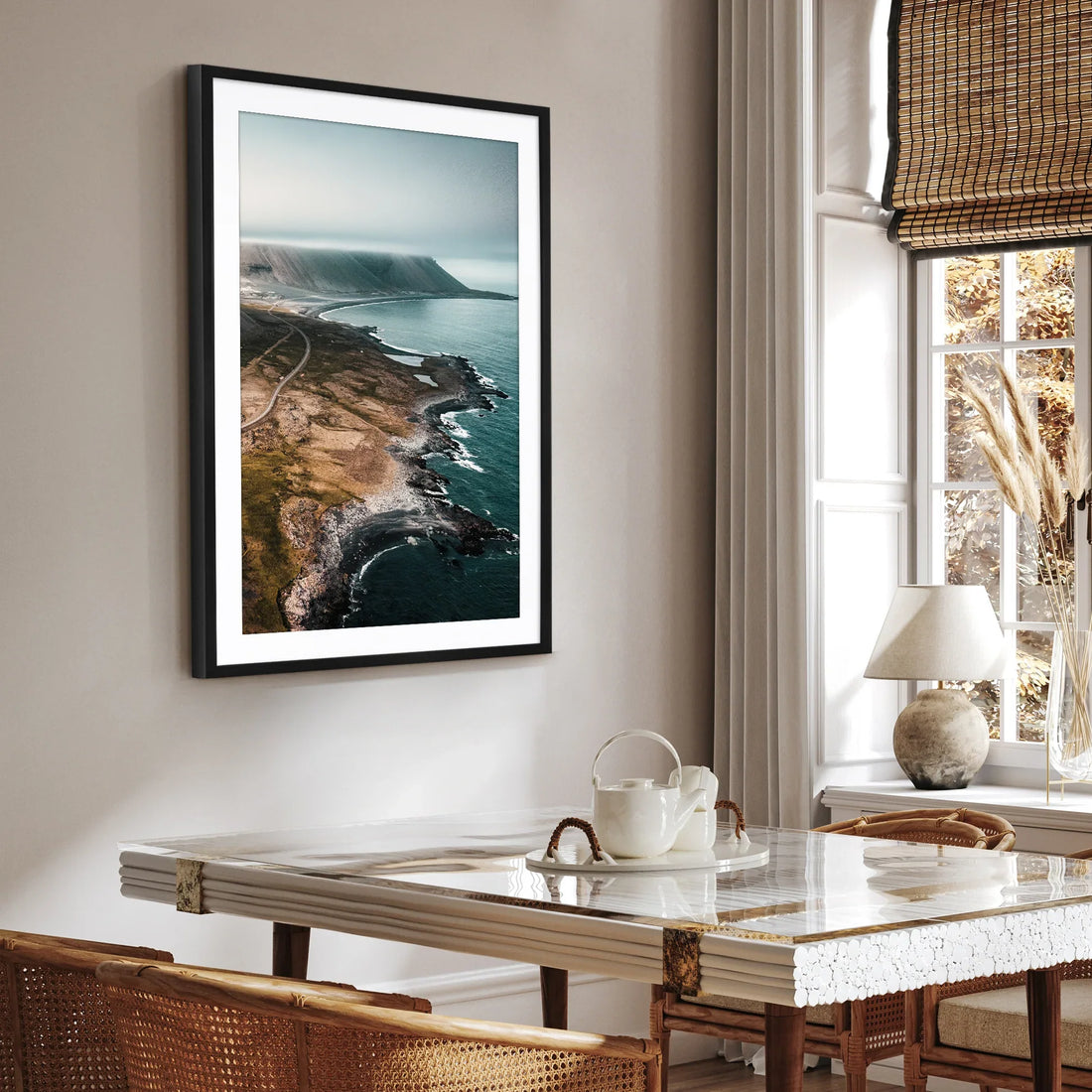 Framed coastal landscape print displayed on living room wall.