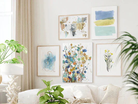 Gallery wall art display above white living area sofa.