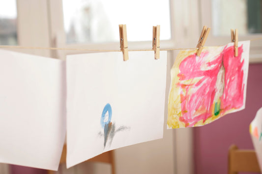 Vivid watercolor paintings on paper hung to dry