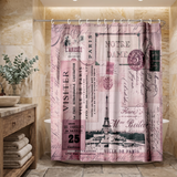 Pink Paris postcard shower curtain, the Eiffel Tower and stamps in a wood and stone bathroom beside folded towels 