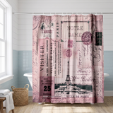Pink Paris postcard shower curtain, the Eiffel Tower and stamps in a bright white bathroom beside a tub and basket 
