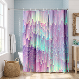 Abstract shower curtain of a pixelated lilac and mint gradient in a bright white bathroom beside a tub and basket 