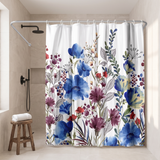Floral shower curtain of blue, purple and red blooms in a walk-in shower beside a black rain head and stool 