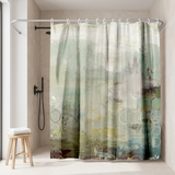Abstract shower curtain in sage, teal and grey washes in a walk-in shower beside a black rain head and stool 