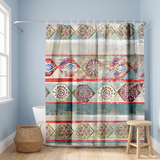 Boho shower curtain of ornate mandala diamonds in red and teal in a blue bathroom beside a freestanding tub and basket 