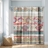 Boho shower curtain of ornate mandala diamonds in red and teal in a bright white bathroom beside a tub and basket 