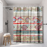 Boho shower curtain of ornate mandala diamonds in red and teal in a walk-in shower beside a black rain head and stool 
