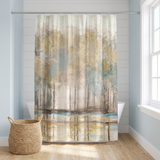 Shower curtain of a misty gold and teal woodland in a bright white bathroom beside a tub and basket 