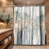 Abstract shower curtain of misty blossom trees in blush and teal in a wood and stone bathroom beside folded towels 
