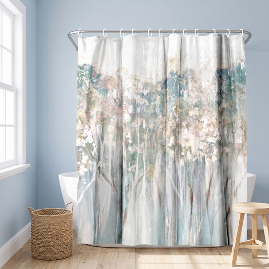 Abstract shower curtain of birch trunks with blush blossom in a blue bathroom beside a freestanding tub and basket #flat