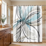 Shower curtain with a large brushed flower in teal and grey in a wood and stone bathroom beside folded towels 