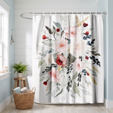 Floral shower curtain of a watercolour bouquet in blush and red in a bright white bathroom beside a tub and basket 