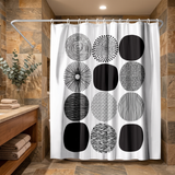 Abstract shower curtain of black and white patterned circles in a wood and stone bathroom beside folded towels 