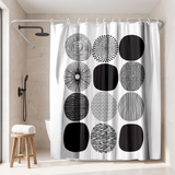 Abstract shower curtain of black and white patterned circles in a walk-in shower beside a black rain head and stool 