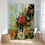 Floral shower curtain of painted coral and cream blooms on dark in a bright white bathroom beside a tub and basket 