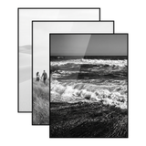 Three black 11x14 frames stacked, a wave crashing onto a shore 