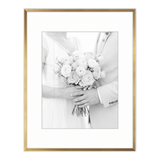 Gold Brooklyn frame with a white mat, holding a photo of a bride holding a bouquet 