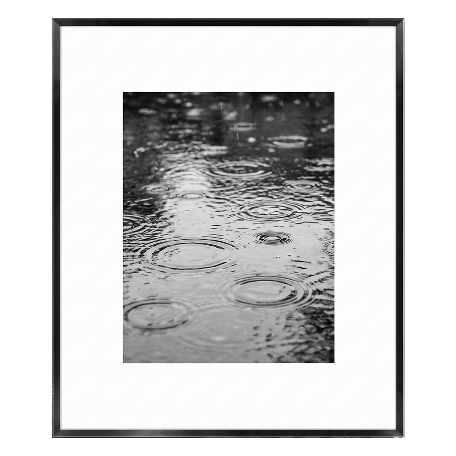 Black Brooklyn frame with a white mat, holding a photo of raindrops rippling on water 