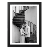 Black 5x7 aluminium float frame, a black-and-white photo of a couple by a spiral staircase 