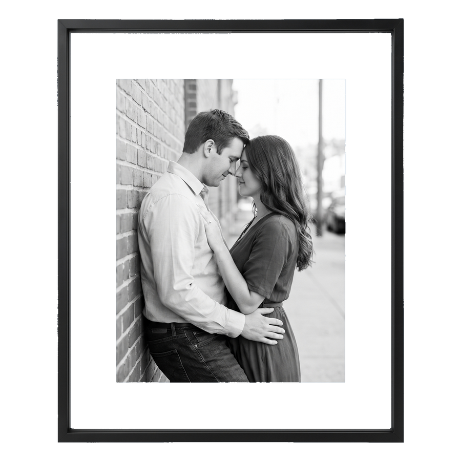 Black 11x14 aluminium float frame, a black-and-white photo of a couple floating on white backing 