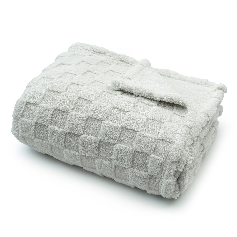 Folded textured gray blanket on a white background #flat
