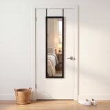 Black 12x48 over-the-door mirror hanging on a dorm room door, reflecting a single bed and desk lamp, with a laundry basket and sneakers nearby