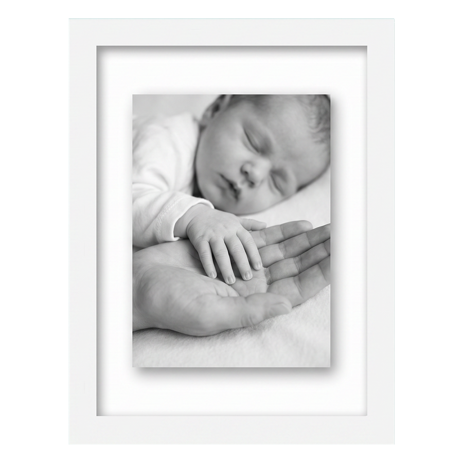 White 8.5x11 float frame, a newborn's hand resting on an adult palm, floating on backing #flat