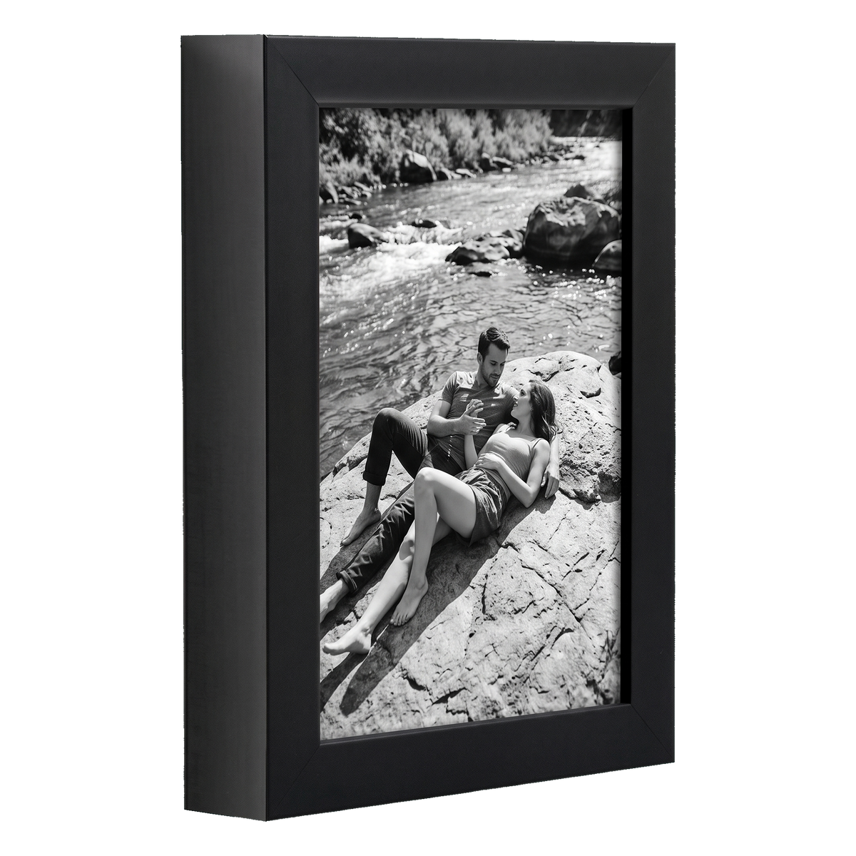 Angled black 5x7 deep frame, a couple sitting on rocks beside a river 
