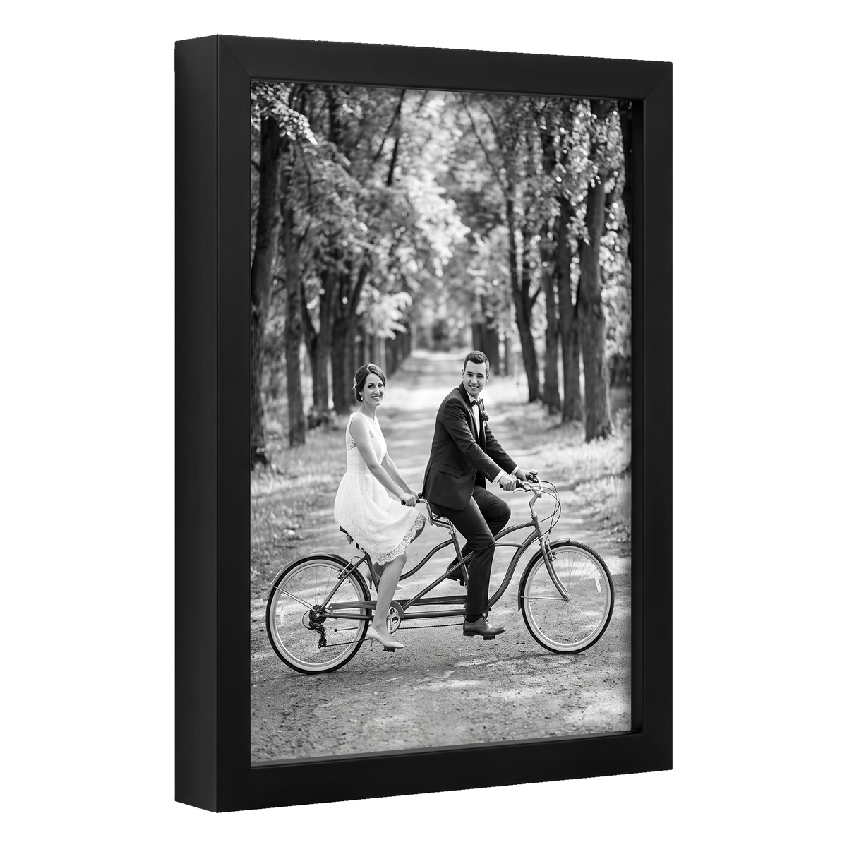 Angled black 8x12 deep frame, a bride and groom riding a tandem bicycle 
