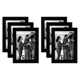 Six black 4x6 frames fanned in two stacks, a couple beside a bicycle on a porch 
