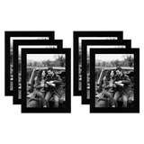 Six black 5x7 frames fanned in two stacks, a couple sitting on a car tailgate 