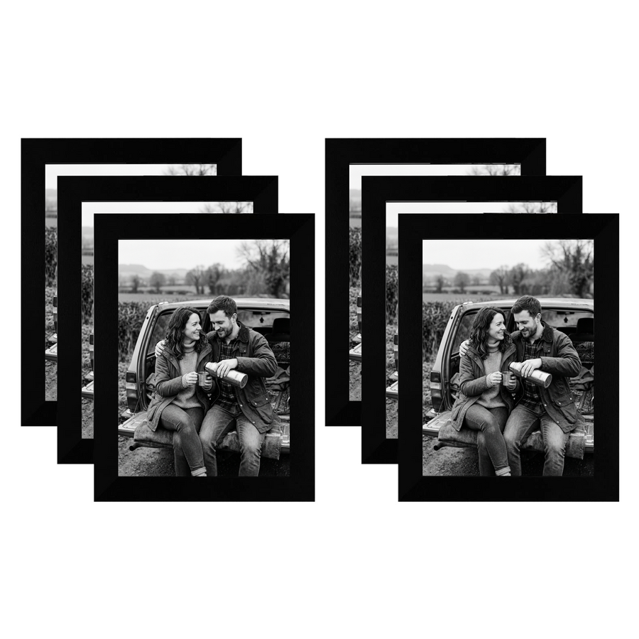 Six black 5x7 frames fanned in two stacks, a couple sitting on a car tailgate #flat