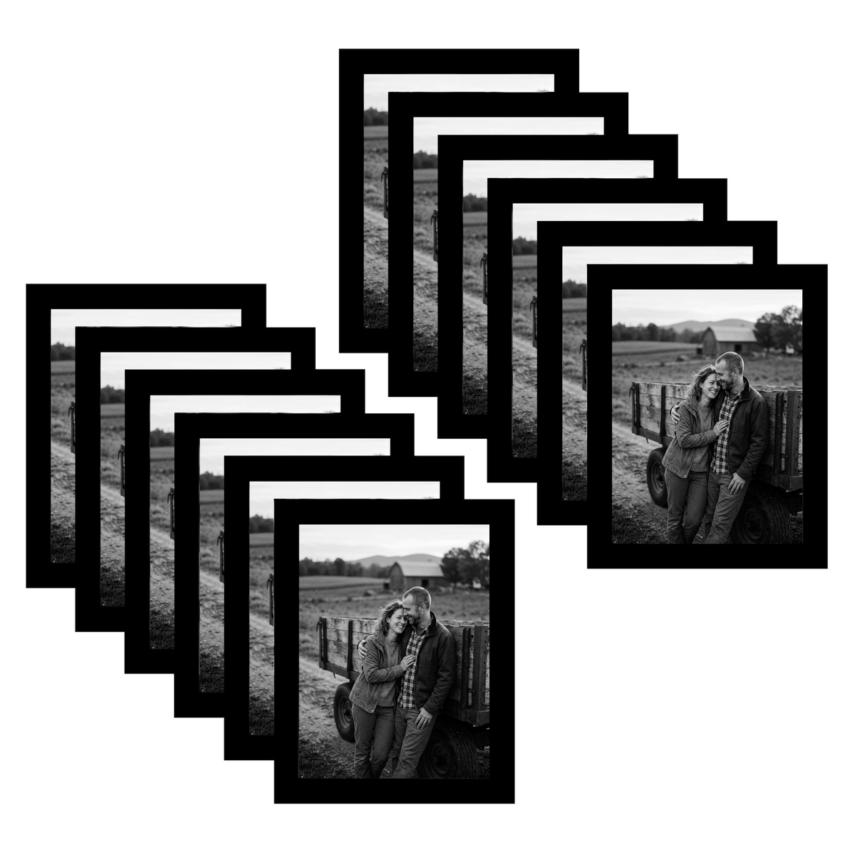 Twelve black 6x8 frames fanned, a couple leaning together on a field fence 