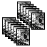 Twelve black 11x14 frames fanned, two people working at a pottery bench 
