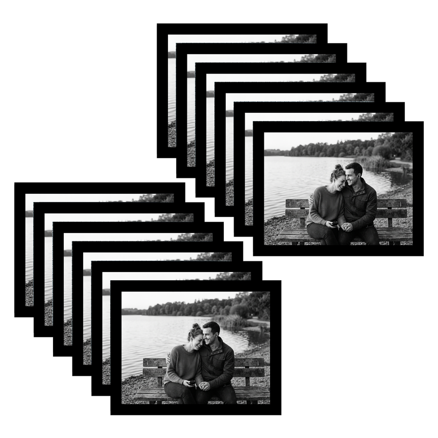 Twelve black 8.5x11 landscape frames fanned, a couple on a bench by a lake #flat