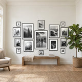 Grand Gallery Wall — fifteen black Hudson frames in a symmetrical salon arrangement above a low bench 