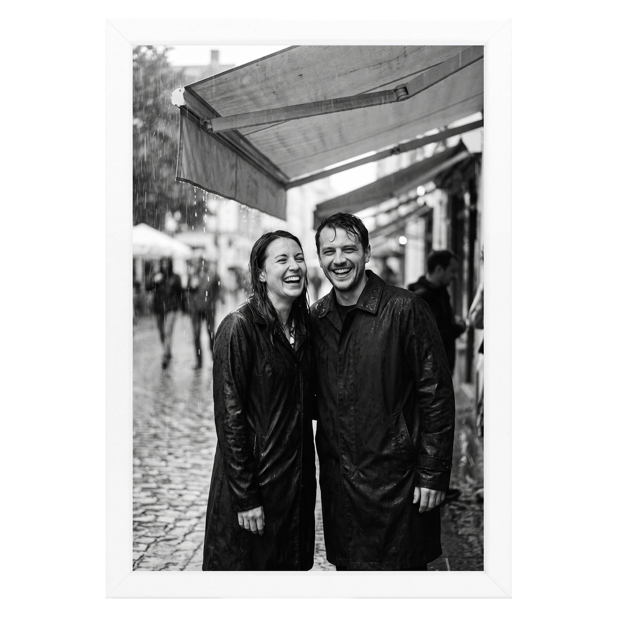 White Streamline frame, 4x6,  no mat, holding a photo of a couple in rain gear at a market 