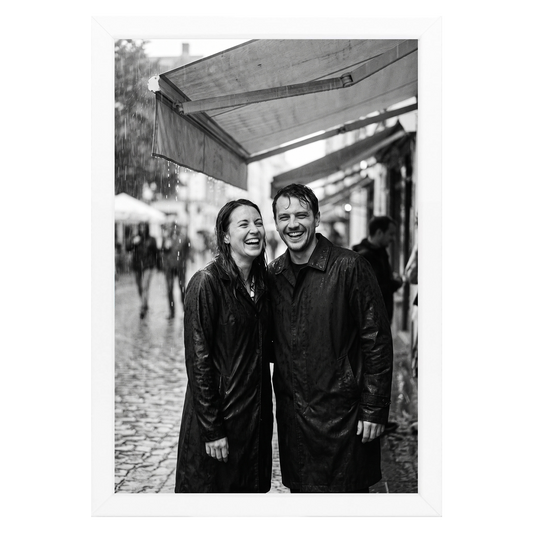 White Streamline frame, 4x6,  no mat, holding a photo of a couple in rain gear at a market #flat