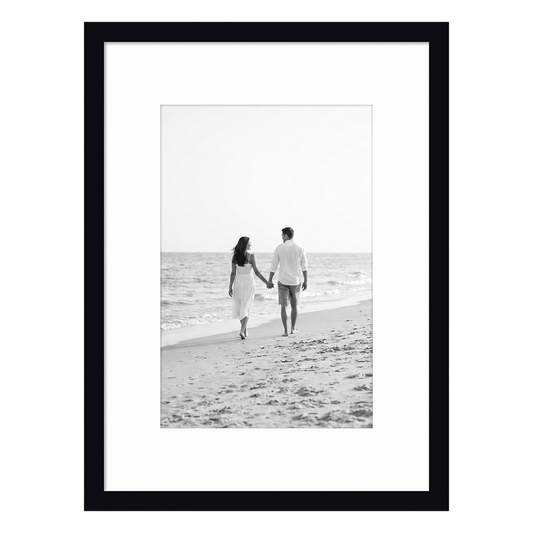 Black Streamline frame, 6x8, with a white mat, holding a black-and-white photo of a couple walking a beach #flat