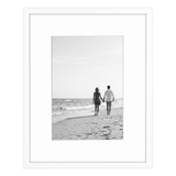 White Streamline frame, 8x10, with a white mat, holding a photo of a couple at a calm shoreline 