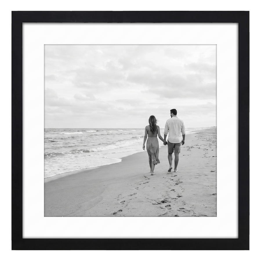 Black Streamline frame, 10x10, with a white mat, holding a photo of a couple walking away on a wide beach 