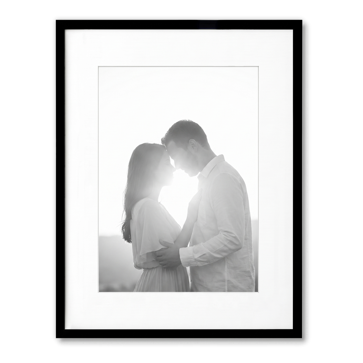Black Streamline frame, 13x16, with a 9x12 white mat, holding a backlit photo of a couple embracing 