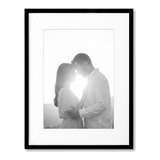 Black Streamline frame, 13x16, with a 9x12 white mat, holding a backlit photo of a couple embracing 