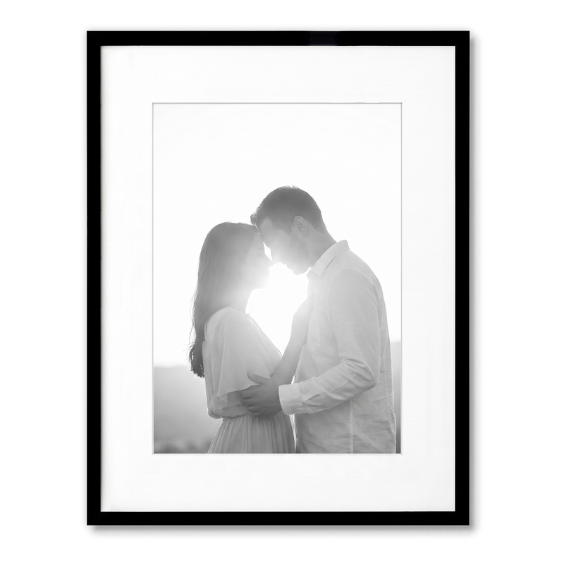Black Streamline frame, 13x16, with a 9x12 white mat, holding a backlit photo of a couple embracing #flat