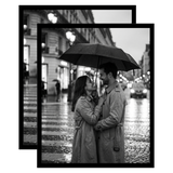 Pair of black Streamline frames, no mat, holding a photo of a couple under an umbrella 